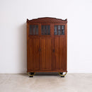 Wooden Art Deco Cabinet with bevelled glass panels on a white background