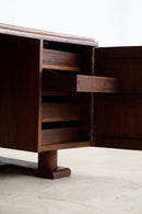 A close-up of a dark brown wooden cabinet with multiple drawers pulled out on the left side, with one drawer open on the right, set against a plain light background.