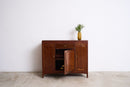 Vintage Art Deco Teak Sideboard with a small plant on a white background