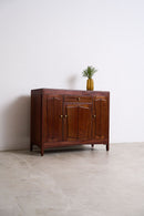 Vintage Art Deco Teak Sideboard with a small plant on a white background