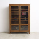 Vintage glass and teak wood cabinet with glass doors on a white background