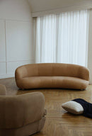 Curved brown leather sofa