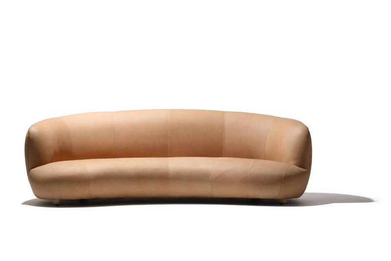 Curved brown leather sofa