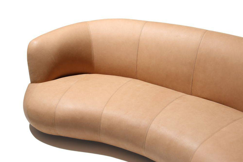 Curved brown leather sofa